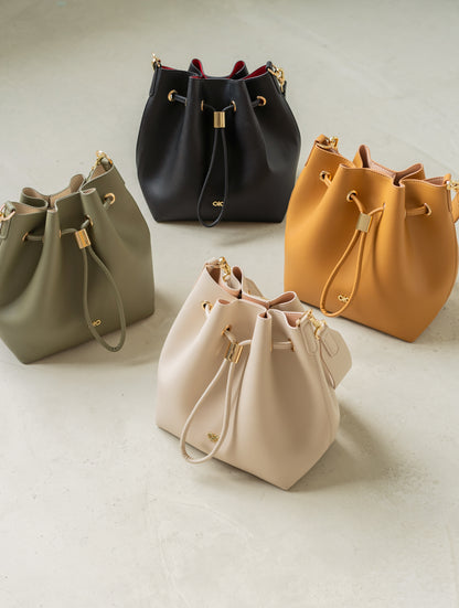 REINA MAGIC BUCKET BAG IN ALMOND